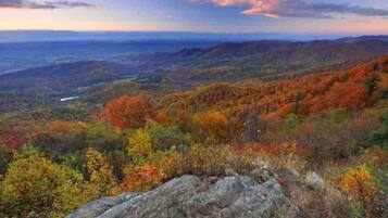 A mountainous landscape with autumn foliage and a clear sky.