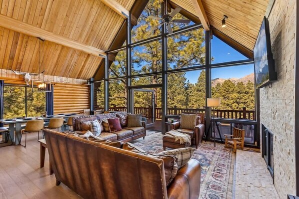 Relax in a spacious room with expansive views, a cozy seating area, and a fireplace.