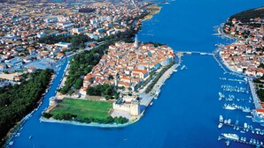 An aerial view of a coastal town with a central fortress, marina, and surrounding residential areas. - Luxury 90 m2 Apt.w.balcony & Spectacular sea View (Seget)