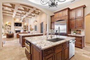 Enjoy cooking in this well-equipped kitchen with a central island, double sink, and dishwasher.