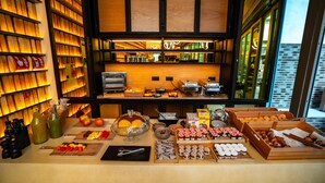 A breakfast buffet with various food items and condiments. - Akeah Hotel Gran Via (Madrid)