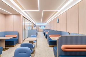 A modern interior with seating arrangements and a visible counter in the background. - Hanting Hotel (Xi'an)