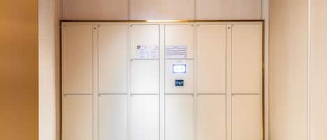 A hotel elevator with numbered doors, a digital display, and a Wi-Fi symbol.