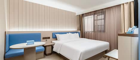 A hotel room with a bed, a sofa, a small table, a TV, and a window with curtains.