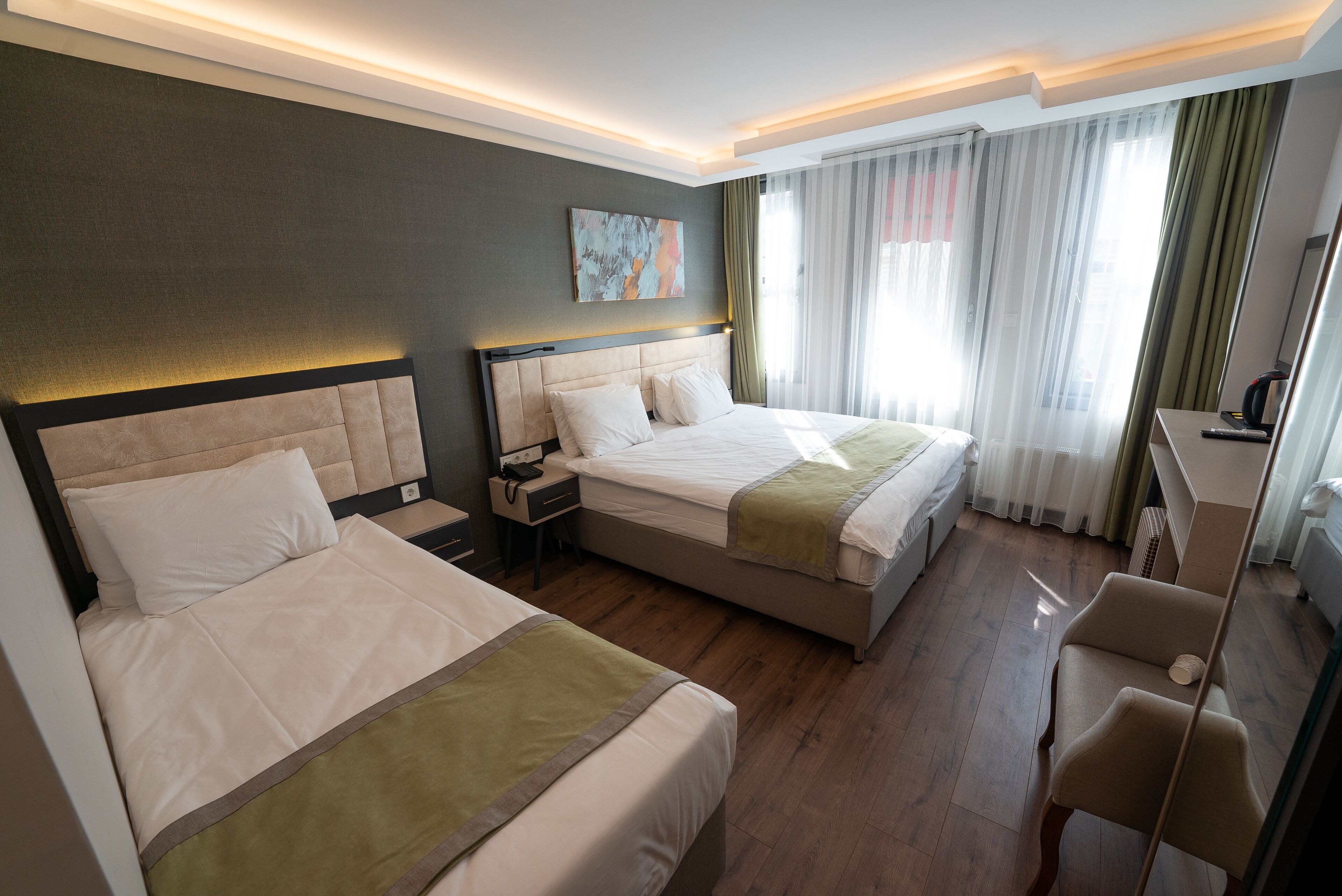 deluxe triple room | 1 bedroom, in-room safe, laptop workspace, blackout curtains