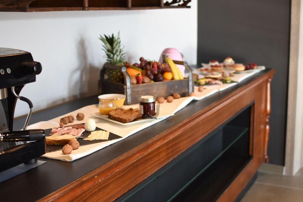 A breakfast buffet with various food items and a coffee machine.
