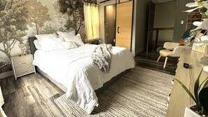 A bedroom with a bed, nightstand, and a large window with curtains. - Casa Mia by the Braves Stadium In Smyrna Ga (Smyrna)