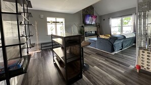 A modern living room with a fireplace, a sofa, and a TV mounted on the wall. - Casa Mia by the Braves Stadium In Smyrna Ga (Smyrna)