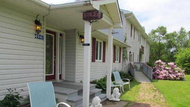A two-story house with a porch, a mailbox, and a number 4941 sign. - Shepody Bay Inn (Shepody)