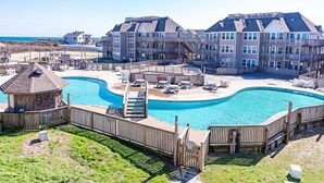 A resort with a large pool, multiple buildings, and a beach view. - Vitamin Sea-Beautiful Oceanfront-3 Bedroom Condo Located in Duck, NC. (Duck)