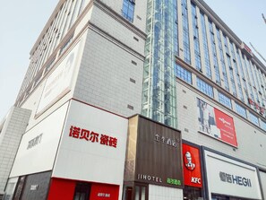 A multi-story building with various commercial establishments including a KFC and a hotel. - Ji Hotel (Wuhan)