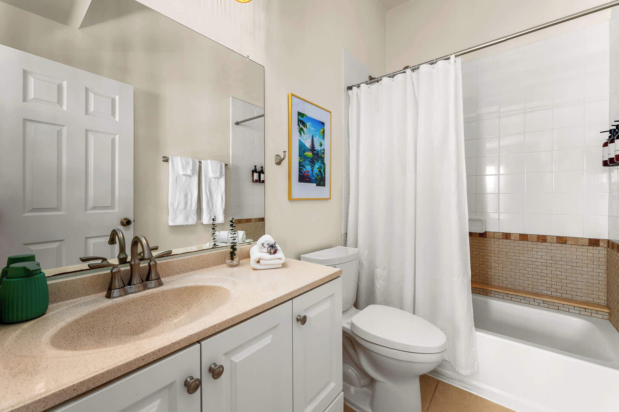 Bathtub, hair dryer, towels, shampoo
