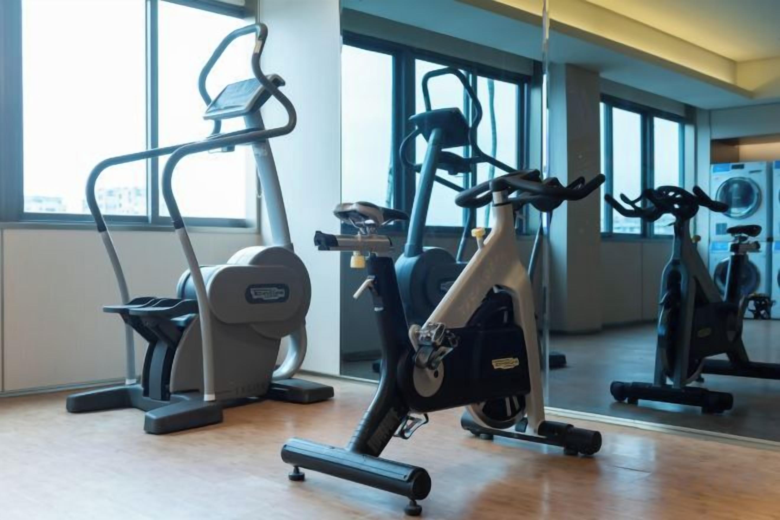 A gym with stationary bikes, treadmills, and exercise equipment.