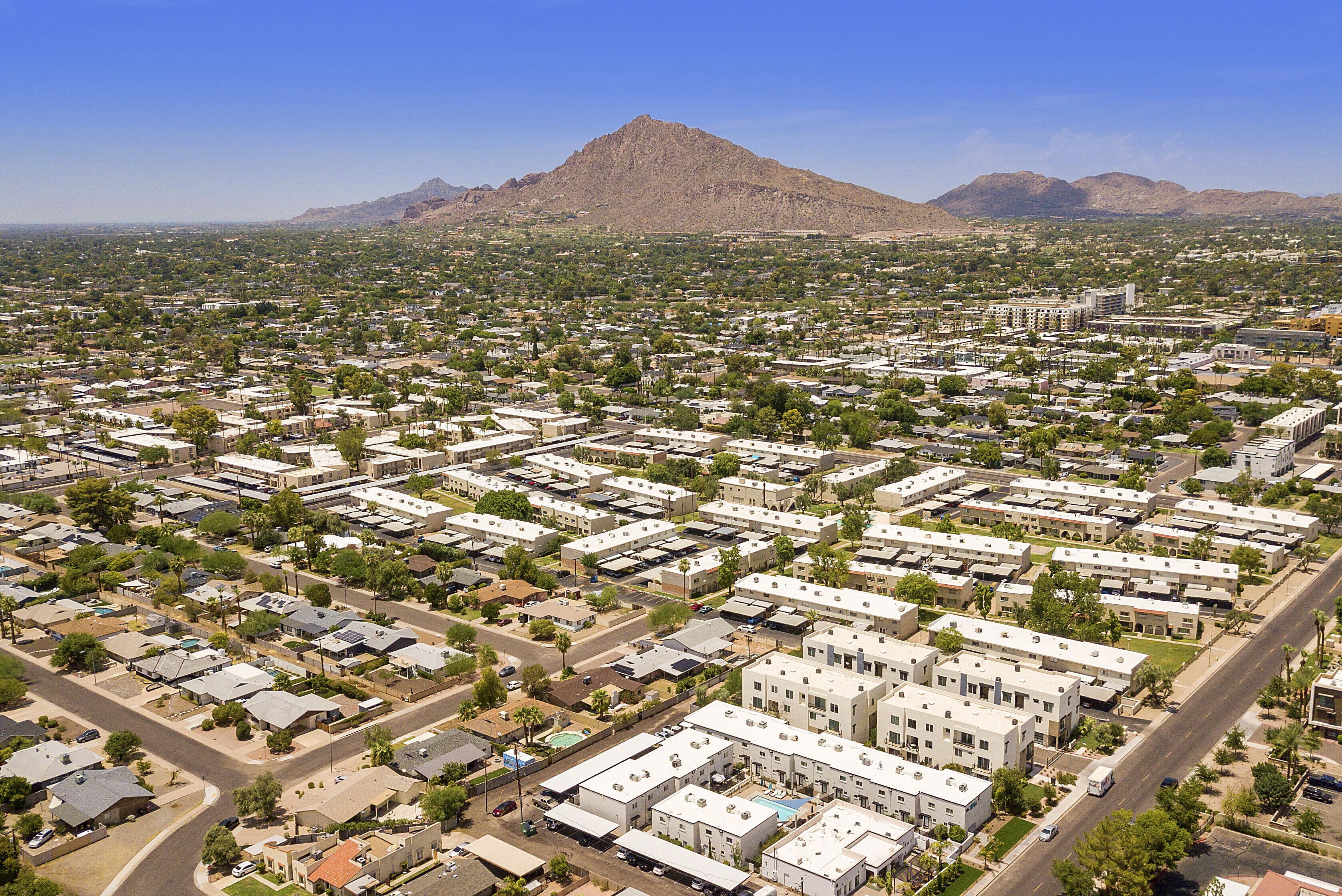 A residential area with a mountain in the background.