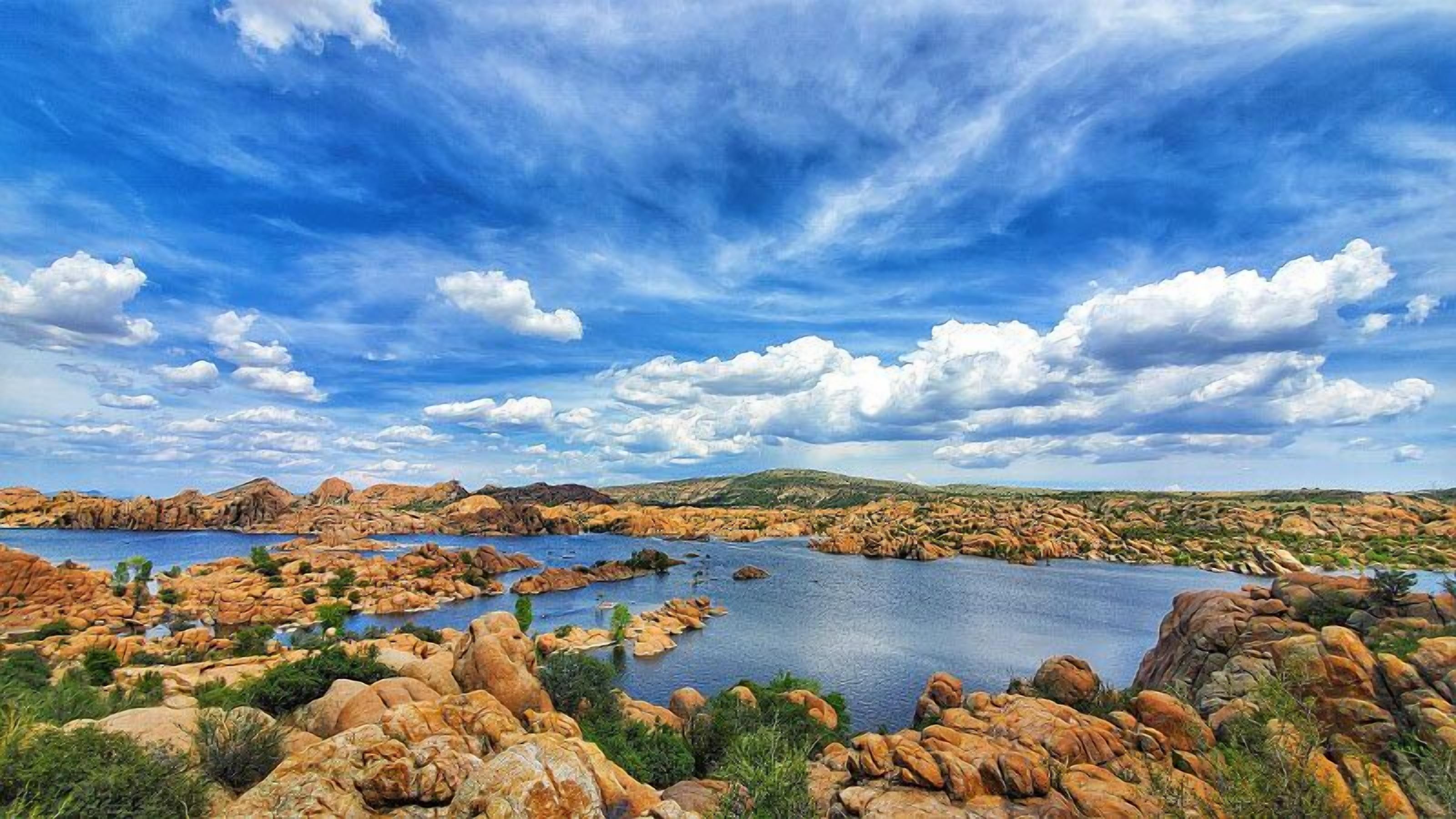 A landscape with rocky terrain and a large body of water.