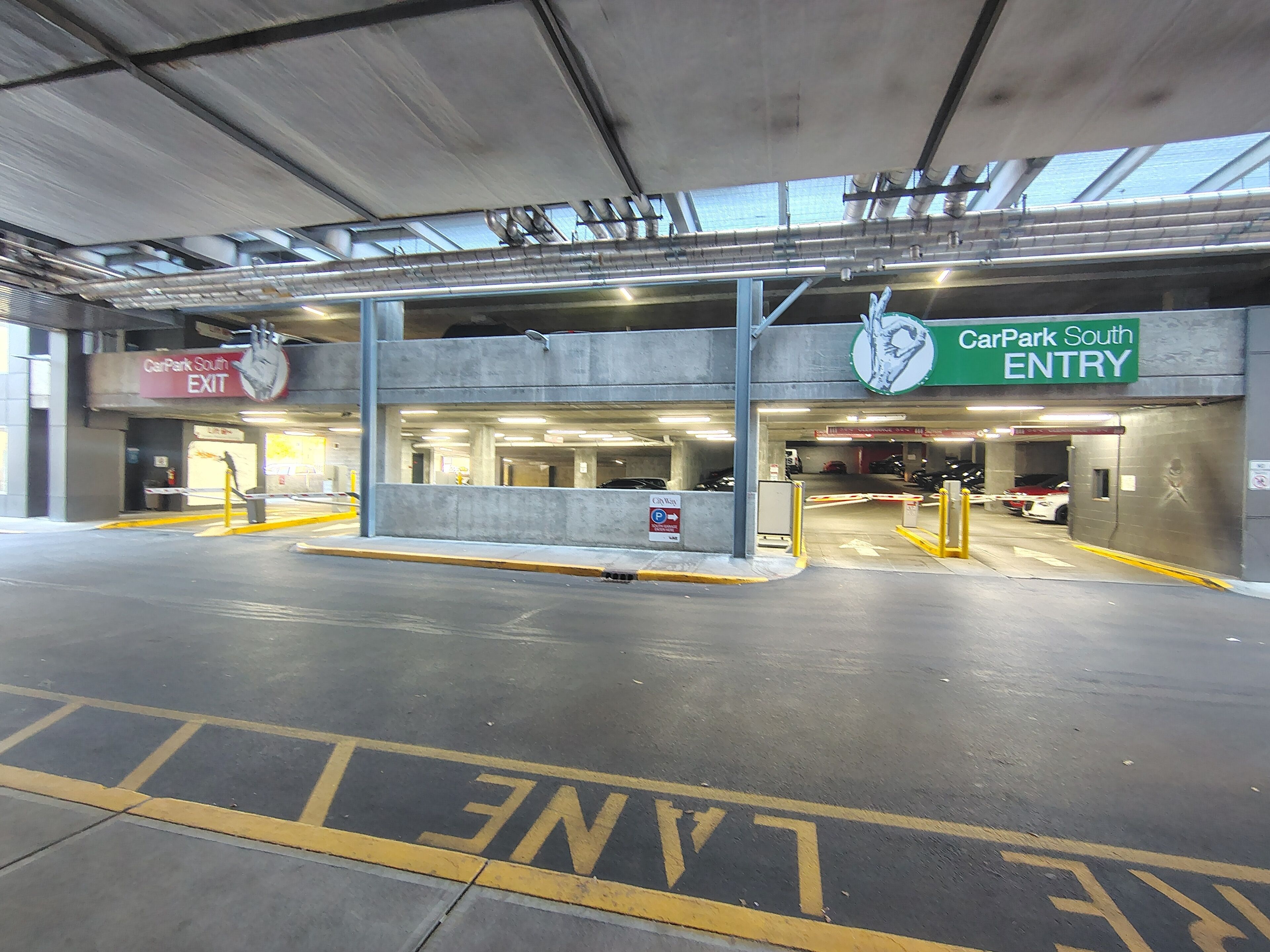 A multi-level parking garage with clear signage for 'CarPark South ENTRY' and 'CarPark South EXIT'.