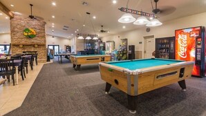 A billiards room with two pool tables, a Coca-Cola vending machine, and a brick fireplace. - Lux 2BR Condo w/Jacuzzi, fast Wifi, Clubhouse, Gym (Branson)