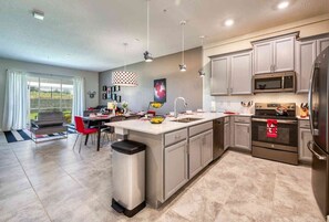 Enjoy cooking in this well-equipped kitchen with a central island, sink, and microwave, and dine in the adjacent seating area.