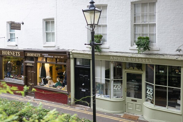 Storefronts of Hornets and Annie Russell, both with large windows and signage.