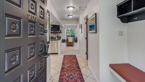 A hallway with a patterned rug, a bench, and a door with a number. - 🏔️Ski-In, Ski-Out Condo~Hot Tub~Interlude 203🏔️ (Snowmass Village)