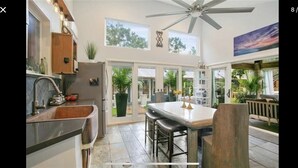 A kitchen with a large island, a ceiling fan, and a view of the outdoors. - BARNDOMINIUM ONE OF A KIND!!! (Mandeville)