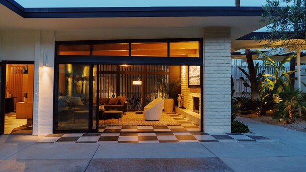 A modern house with a checkered floor, a glass door entrance, and a cozy interior with a sofa and a lamp. - Azure Sky Hotel - Adults Only - A Town & Desert Boutique Hotel (Palm Springs)