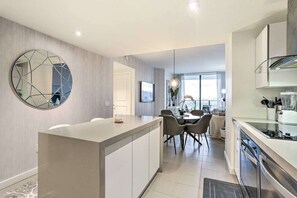Enjoy cooking and dining in this spacious kitchen with a central island, round table, and sleek appliances.