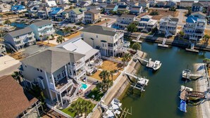 Une zone résidentielle côtière comprenant des maisons, des quais et un port de plaisance.