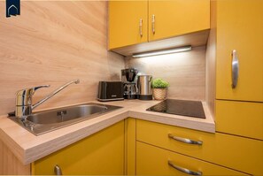 Fridge, stovetop, dishwasher, coffee/tea maker