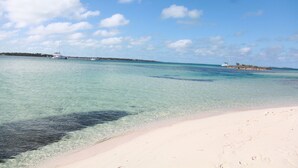 A beach with clear turquoise water and a sandy shore. - Tranquility reigns at Talisman (Elbow Cay)