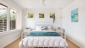 A bedroom with a white bed, a nightstand, a ceiling fan, and a window with blinds. - Pet Friendly - Preston Alfresco Poolside Retreat Rye (Rye)