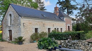 A stone building with a sloped roof, multiple windows, and a chimney. - A dream holiday in the heart of nature in a historic setting (Beaumont-Louestault)