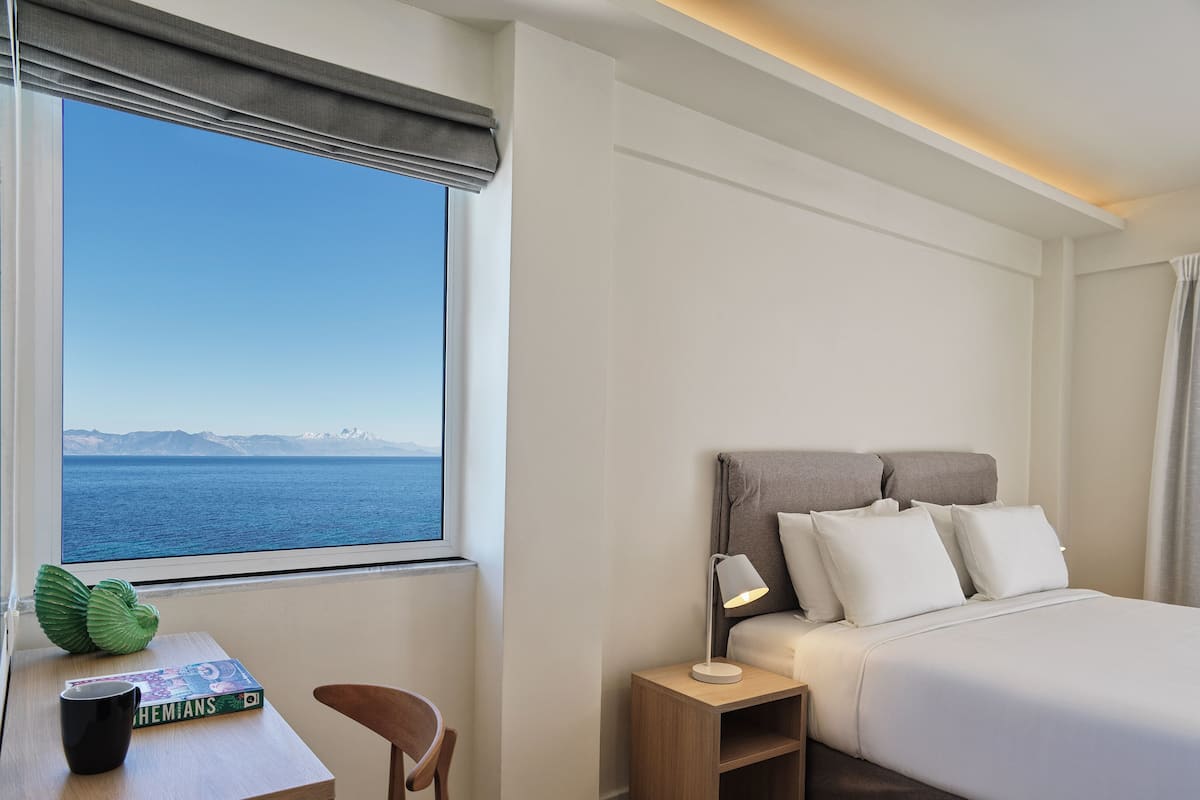 Deluxe Room, Partial Sea View | 1 bedroom, premium bedding, minibar, in-room safe