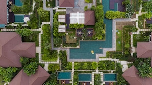 An aerial view of a resort with multiple swimming pools, lush greenery, and a central courtyard. - Angkor Green Gardens by Dara (Siem Reap)