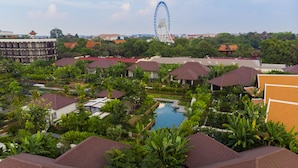 A resort with multiple bungalow-style buildings, a central swimming pool, and a Ferris wheel in the background. - Angkor Green Gardens by Dara (Siem Reap)