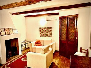 Relax in this inviting living room with a sofa, coffee table, and fireplace.