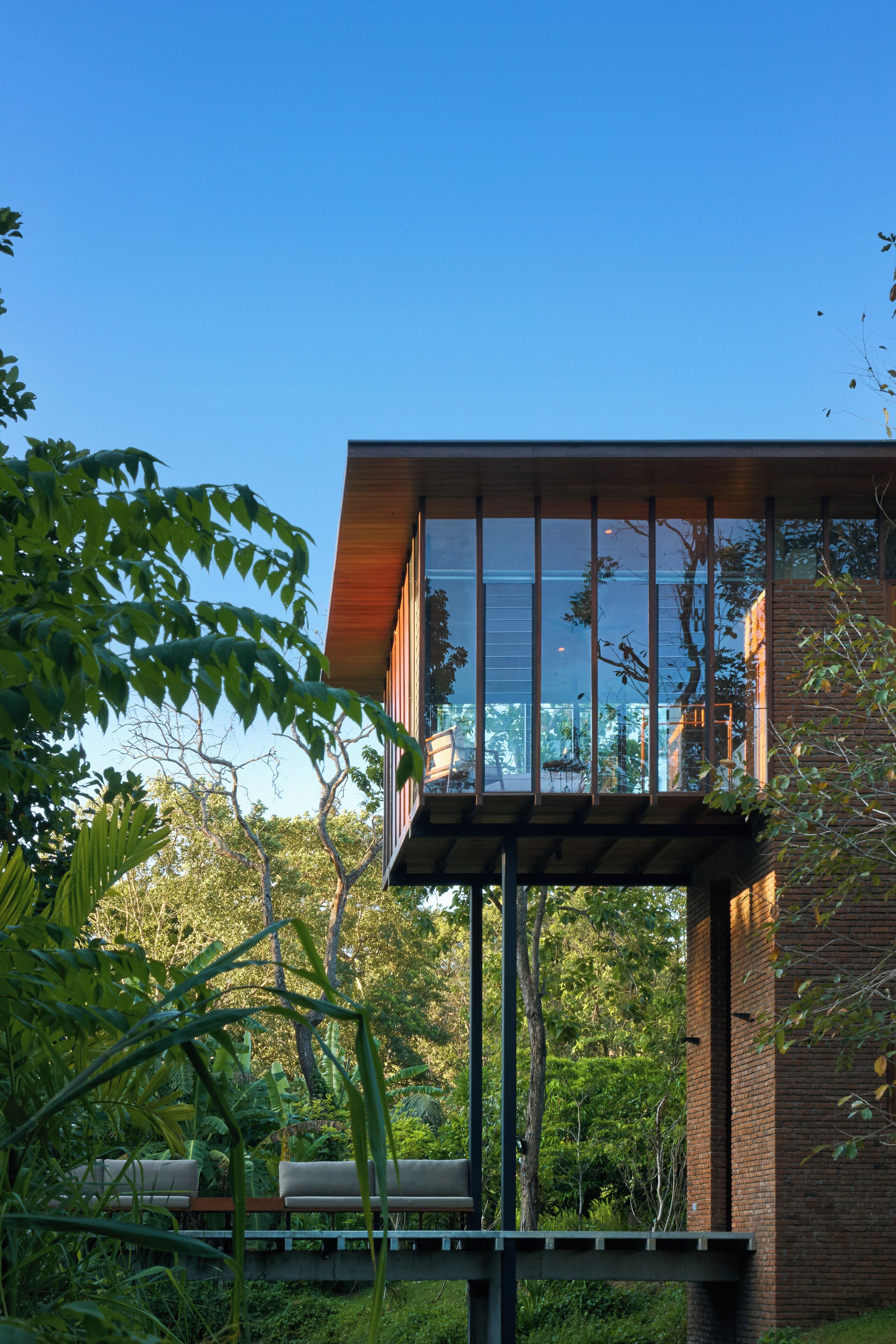 A modern building with large windows and a wooden deck.