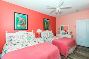 A room with two beds, a ceiling fan, and two framed pictures on the wall. - Sea-Esta! 4BR Townhome with Community Pool & easy beach access! (Surf City)