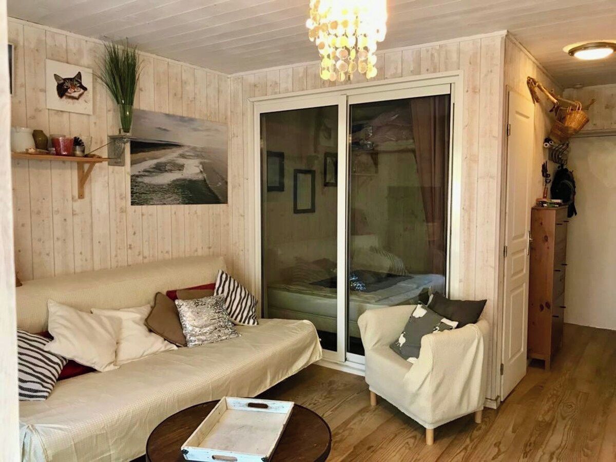 A cozy living room with a sofa, armchair, and a coffee table.