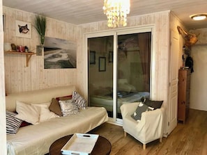 A cozy living room with a sofa, armchair, and a coffee table. - Welcoming apartment with terrace A0314 (Cap-Ferret)
