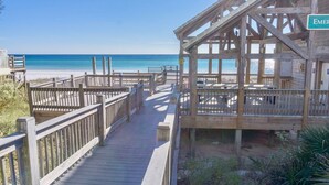 A wooden boardwalk leading to a beach with a wooden structure labeled "EMERGENCY" on the right. - Pet Friendly ~ Bunk Room ~ Community Pool (Miramar Beach)