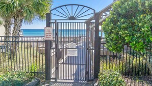 A gated entrance to a private property with a beach view, a lifeguard duty sign, and a no tents allowed sign. - Pet Friendly ~ Bunk Room ~ Community Pool (Miramar Beach)