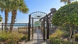 A gated entrance to a beach pavilion with a sign indicating it is for owner and guests. - Gated Community ~ Spacious Living ~ Patio (Miramar Beach)