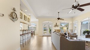 A spacious living area with a sofa, chairs, and a ceiling fan. - Gated Community ~ Spacious Living ~ Patio (Miramar Beach)
