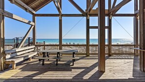 A wooden deck with a picnic table and benches overlooking a beach. - Gated Community ~ Spacious Living ~ Patio (Miramar Beach)