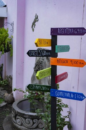 A directional signpost with distances to various countries.