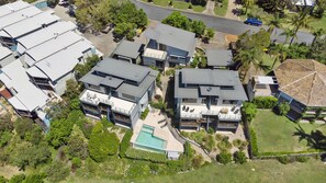 A residential area with modern houses, a swimming pool, and a road. - Luxury, magnificent views, space and swimming pool (Point Lookout)