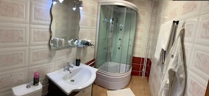 Combined shower/tub, hair dryer, towels, soap
