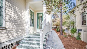 A residential property with a front porch, steps, and a pathway leading to the entrance. - Gorgeous Watercolor Home Close to  Camp with NEW 6  "LSV" Low Speed Vehicle. (SANTA ROSA BEACH)