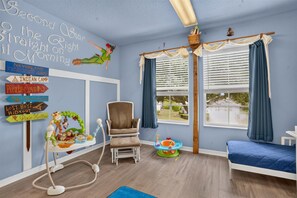 A cozy nursery corner with a comfortable chair and colorful accents. - Disney-Themed Villa with Heated Pool & Playroom (Davenport)